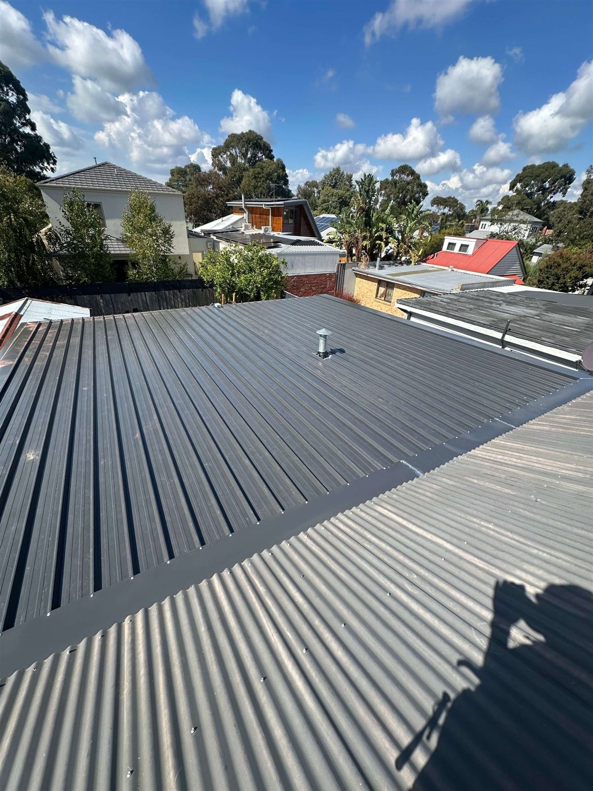 Suburban Brisbane rooftops, tile and metal roofs in The Gap